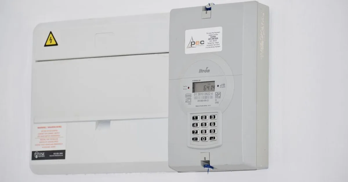 Electrical meter and fuse box on a white wall in Cape Town, South Africa, for energy monitoring or billing.
