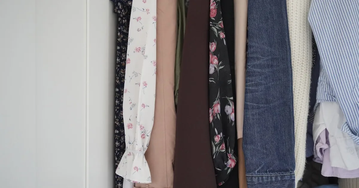 Assortment of clothes hanging in a closet