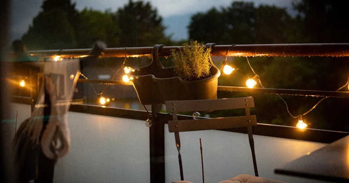 a balcony with a chair and a potted plant on it