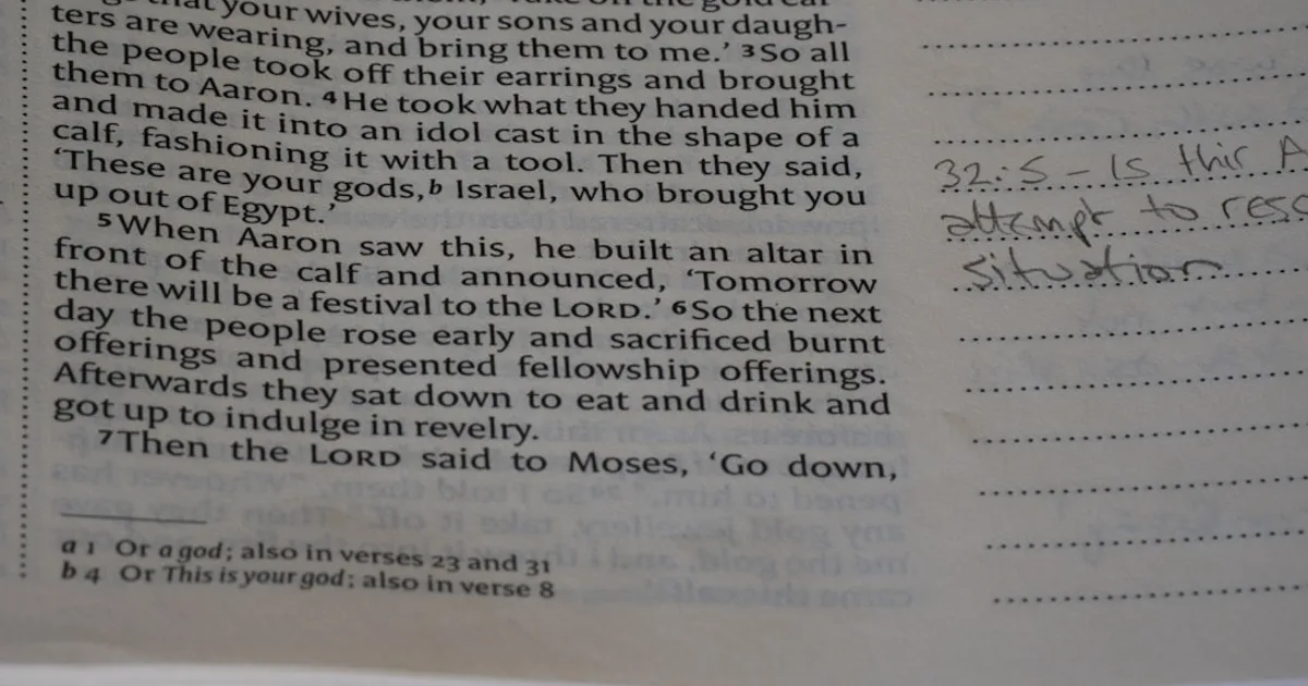 Close-up of an open bible with handwritten notes.